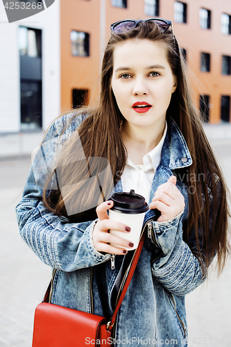 Image of young pretty hipster girl student with coffee cup posing adorable smiling, lifestyle people concept outdoor