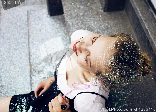 Image of young pretty party girl smiling covered with glitter tinsel, fas