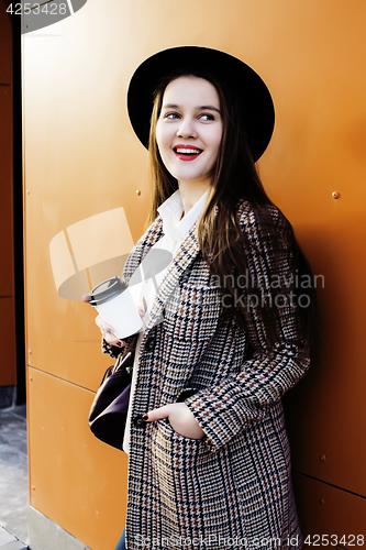 Image of young pretty hipster girl student with coffee cup posing adorable smiling, lifestyle people concept outdoor