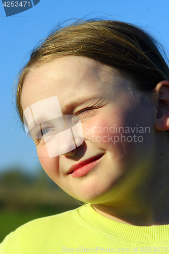 Image of little girl squinting