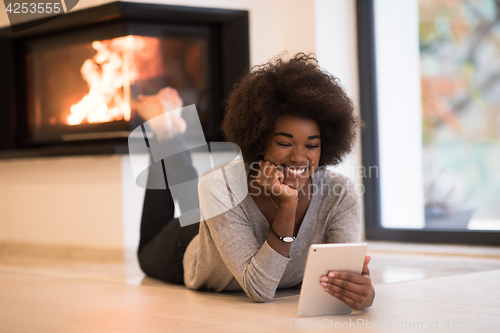 Image of black women using tablet computer on the floor