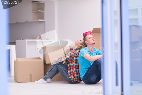 Image of young couple moving  in new house