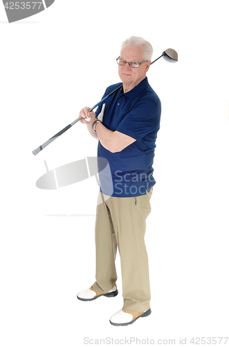 Image of Senior practicing golf at home.