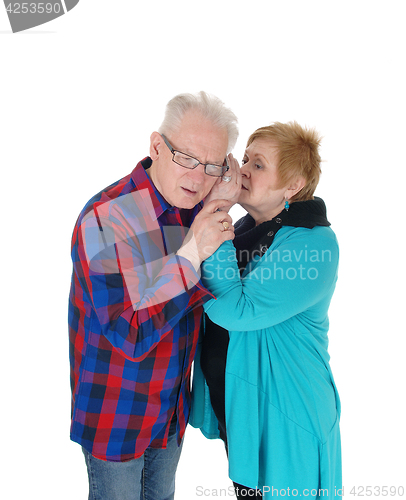 Image of Wife whisper in husband ear.