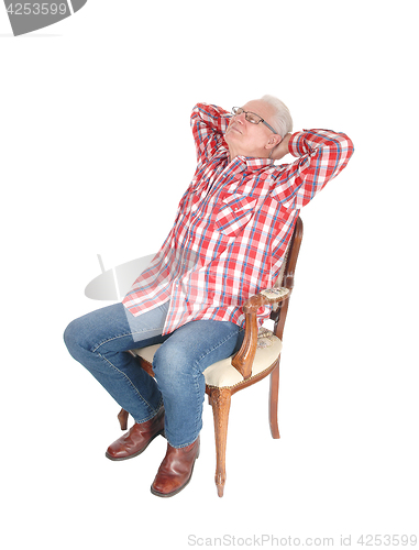 Image of Senior man relaxing on chair.