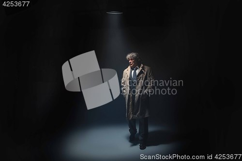 Image of The senior man as detective or boss of mafia on gray studio background