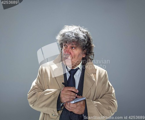 Image of The senior man as detective or boss of mafia on gray studio background