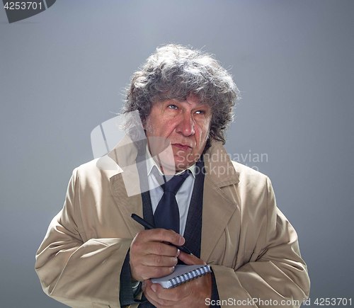 Image of The senior man as detective or boss of mafia on gray studio background