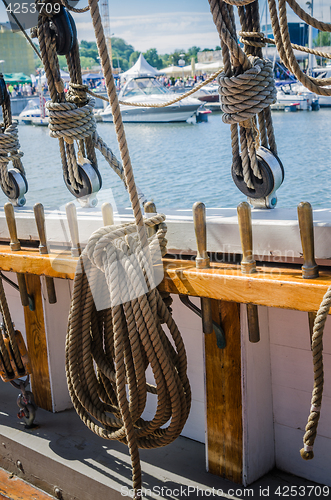 Image of Rigging on the old sailboat against the background of modern yac