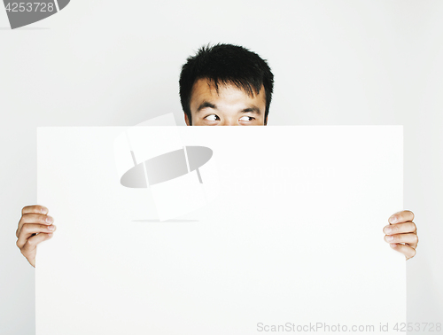 Image of pretty cool asian man holding empty white plate smiling