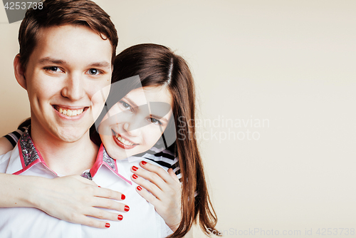 Image of young pretty teenage couple, hipster guy with his girlfriend happy smiling and hugging isolated on white background, lifestyle people concept close up