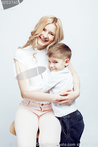 Image of young modern blond curly mother with cute son together happy smiling family posing cheerful on white background, lifestyle people concept, sister and brother friends