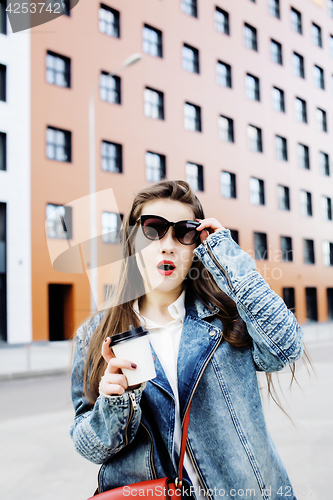 Image of young pretty hipster girl student with coffee cup posing adorable smiling, lifestyle people concept outdoor