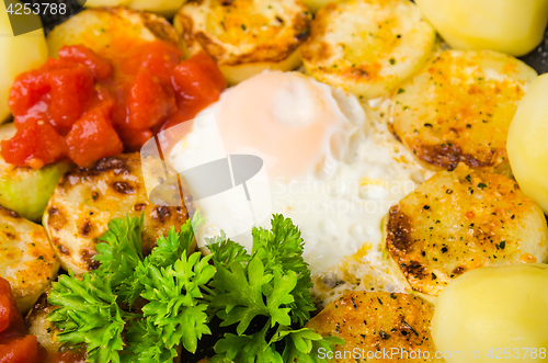 Image of Scrambled eggs with zucchini and vegetables, close-up