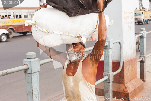 Image of Man carrying load on the Howrah Bridge