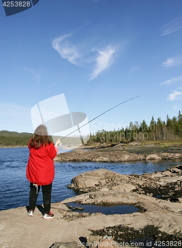 Image of Woman fishing by a lake