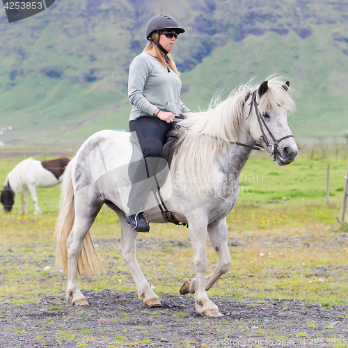 Image of Woman riding a horse