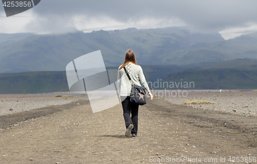 Image of Woman hiker walking in mountain landscape