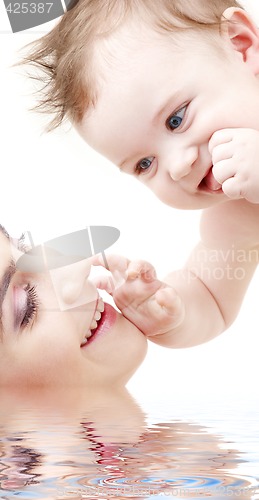 Image of happy blue-eyed baby boy touching mama