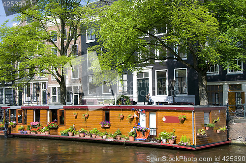 Image of amsterdam holland canal house boat with flowers