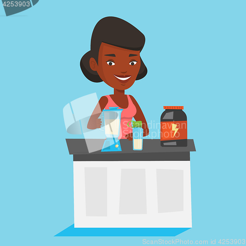Image of Young woman making protein cocktail.