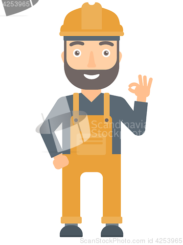Image of Smiling builder showing ok sign.