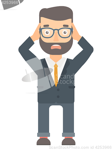 Image of Stressful office worker clutching his head.