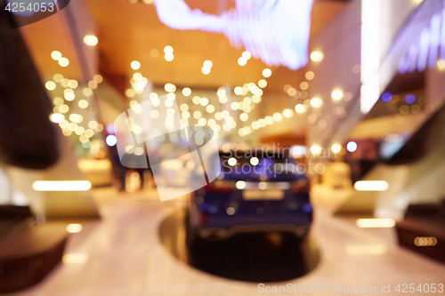 Image of Blurred, defocused background of public event exhibition hall showing cars and automobiles