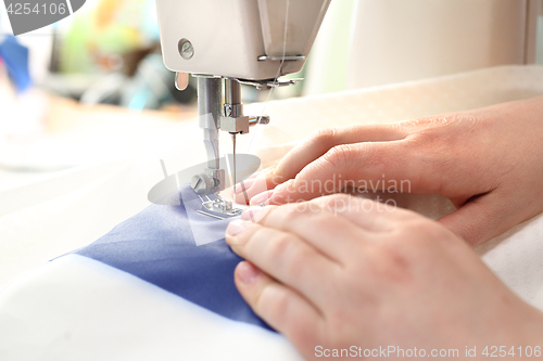 Image of Woman sewing on the sewing machine