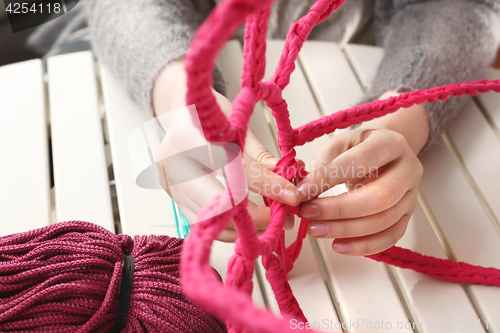 Image of Knitting crochet. The woman knits crochet.