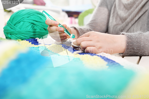 Image of Knitting crochet. The woman knits crochet.