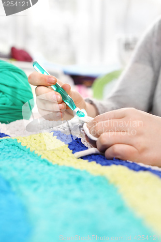 Image of Knitting crochet. The woman knits crochet.