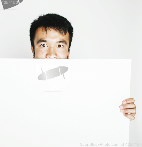 Image of pretty cool asian man holding empty white plate smiling