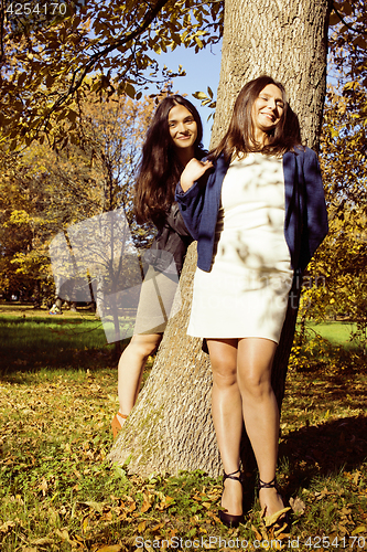 Image of mature real mother with daughter outside autumn fall in park