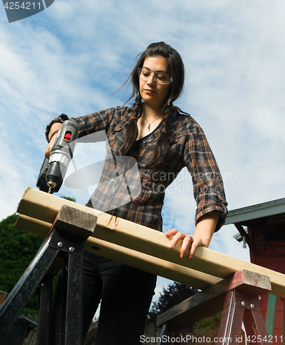 Image of Craftsperson Woman Uses Power Screwdriver Drilling Holes Wood