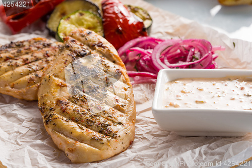 Image of Grilled chicken breast with fries and salad