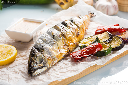 Image of fish baked on the grill. with potatoes and lemon. 