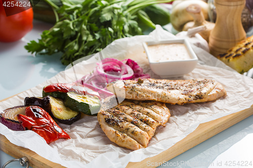 Image of Grilled chicken breast with fries and salad