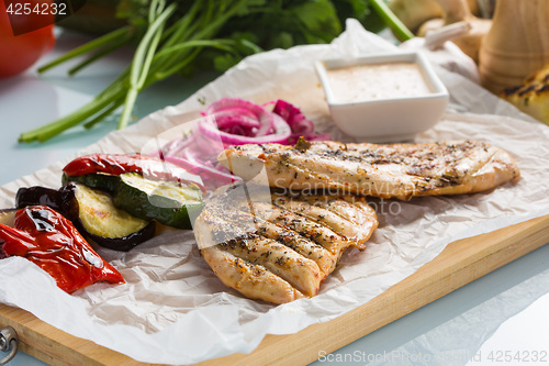 Image of Grilled chicken breast with fries and salad