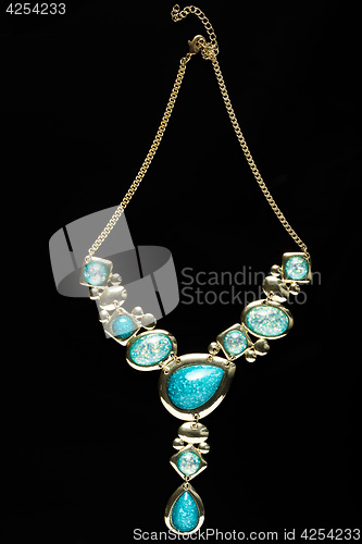 Image of necklace on a black background. gems. 