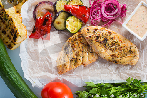 Image of Grilled chicken breast with fries and salad