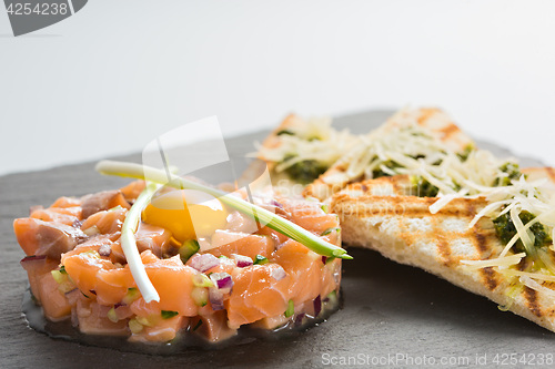 Image of fish tartare with quail egg 