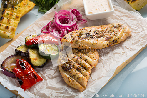 Image of Grilled chicken breast with fries and salad