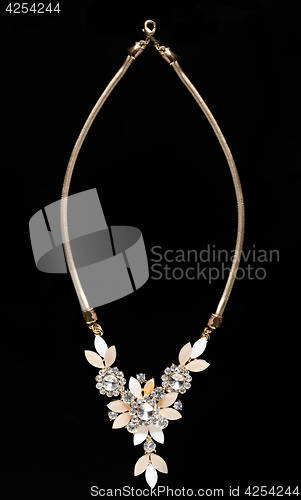 Image of necklace on a black background. gems. 