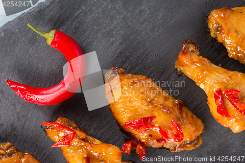 Image of fried chicken wings on a black slate plate 