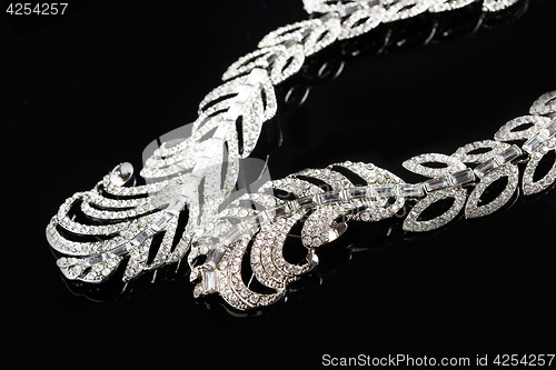 Image of necklace on a black background. gems. 