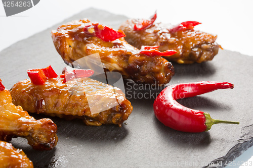 Image of fried chicken wings on a black slate plate 
