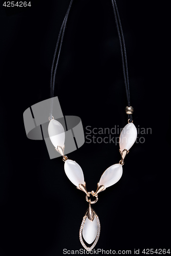 Image of necklace on a black background. gems. 