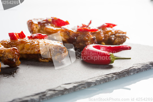 Image of fried chicken wings on a black slate plate 