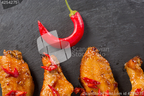 Image of fried chicken wings on a black slate plate 